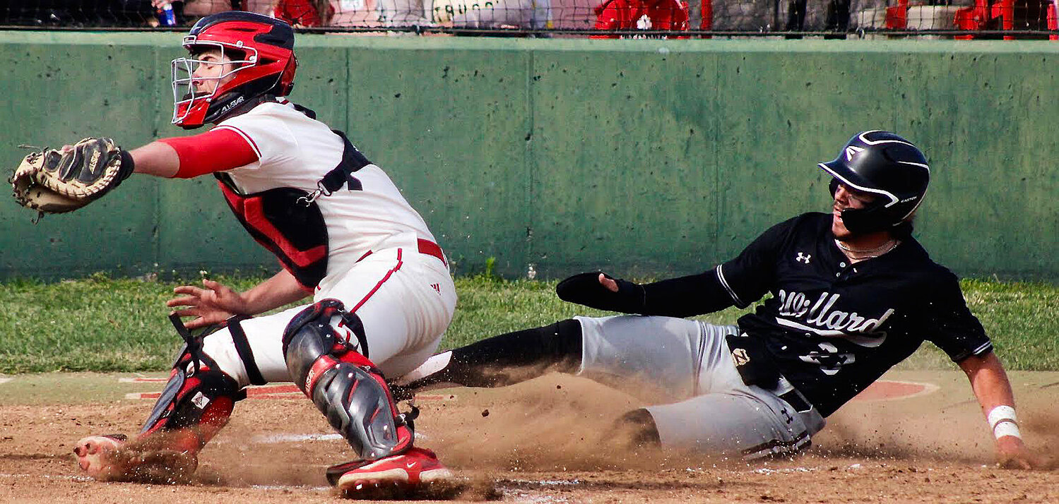 OZARK'S COOPER BUVID get set to make a tag at home plate.