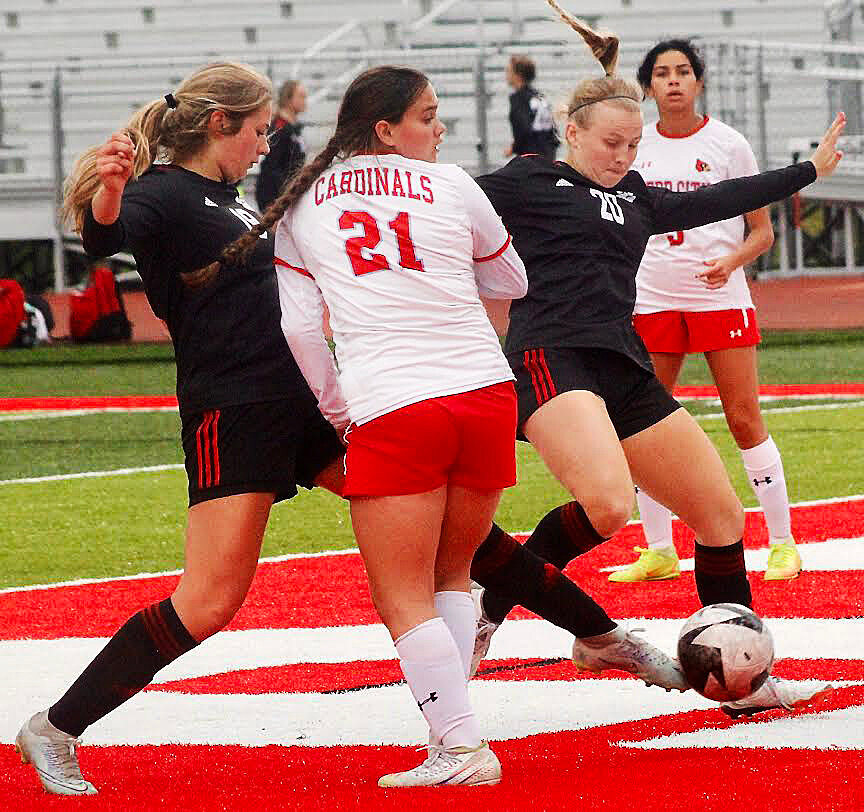 OZARK'S AUDREY CARLTON boots a shot on goal in traffic.