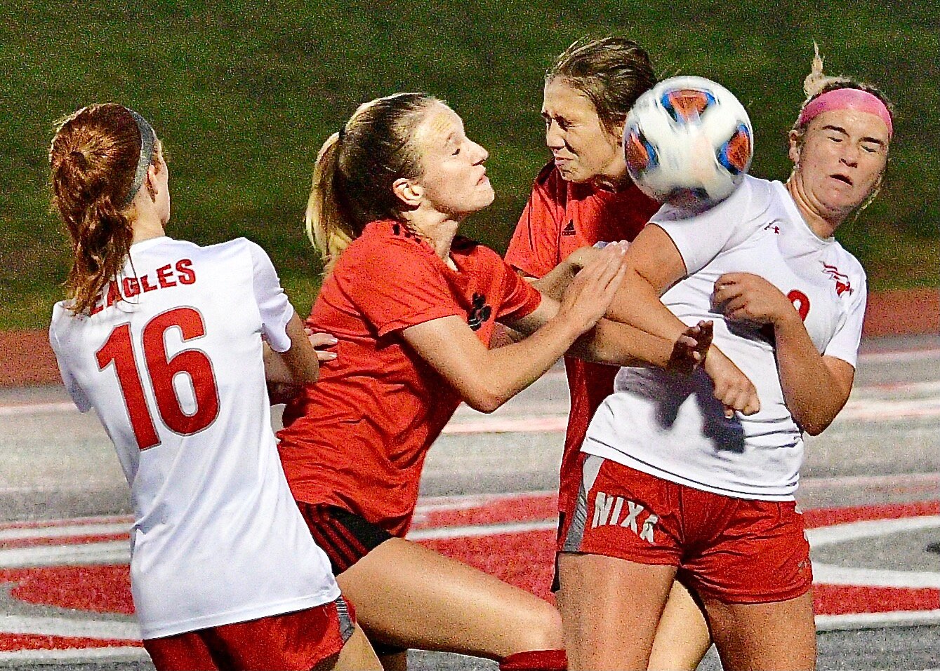 NIXA'S MACKINZIE HARRIS AND SHAELEE FRANCK AND OZARK'S ADDIE SHULER battle for possession of the ball Tuesday.