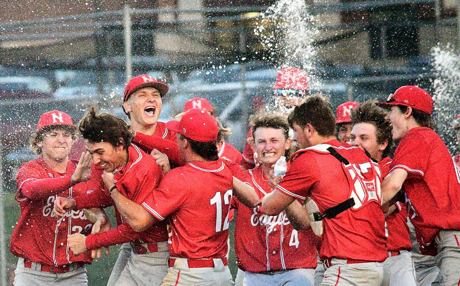 NIXA'S COLIN KELLEY is mobbed by teammates during the Eagles' Class 6 District 5 championship celebration Thursday.