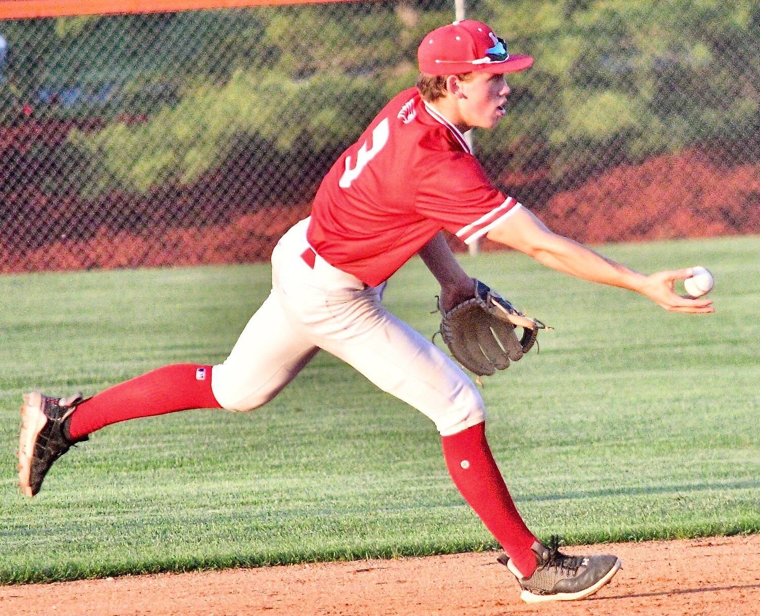 NIXA'S CAEDEN CLOUD tosses the ball to second base for a forceout.