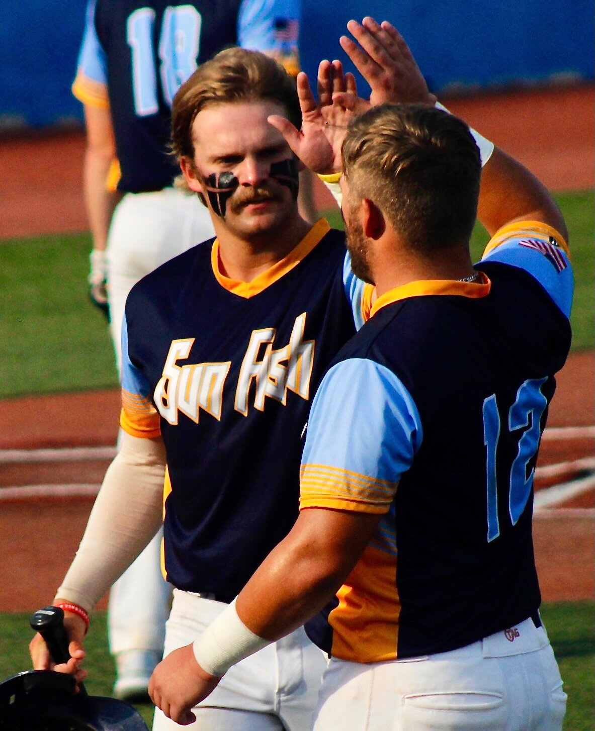 SUN FISH'S ZACH BURGHER AND CHASE MCKAGUE exchange a high-five.