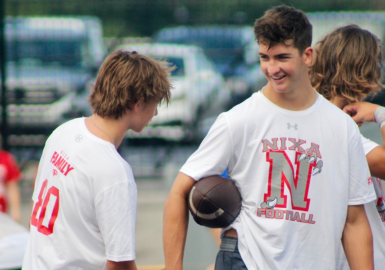 NIXA'S DREW BLEVINS, right, chats with teammates during an Eagles practice.