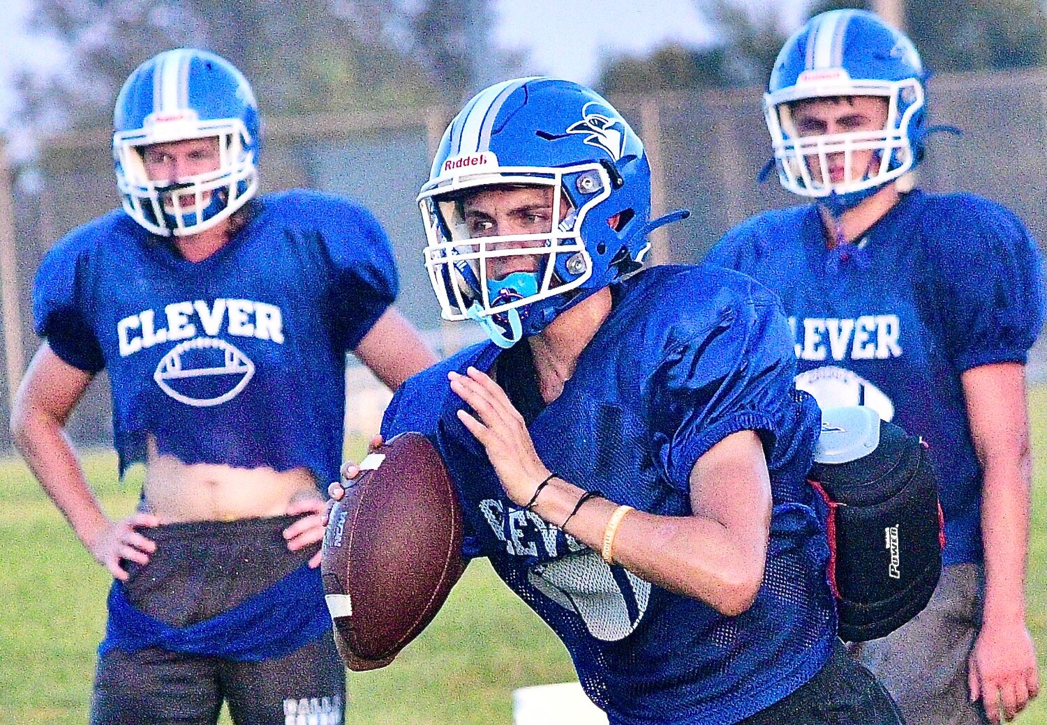 CLEVER'S GAGE EVANS gets set to throw downfield as teammates Blake Steele and Austin Scott watch.