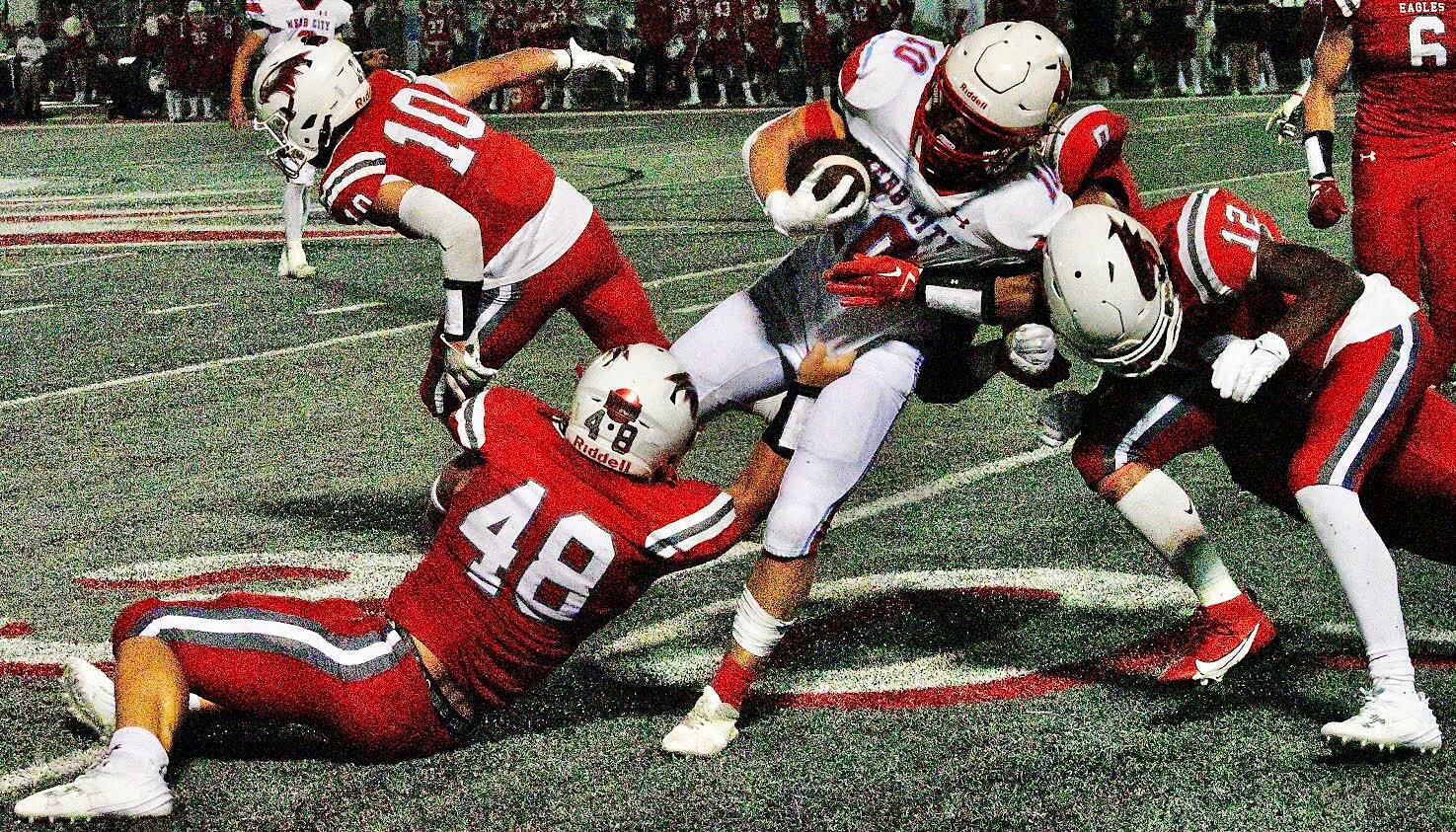 NIXA'S ELI FRAZIER AND BRAYDEN PARKS combine for a tackle.