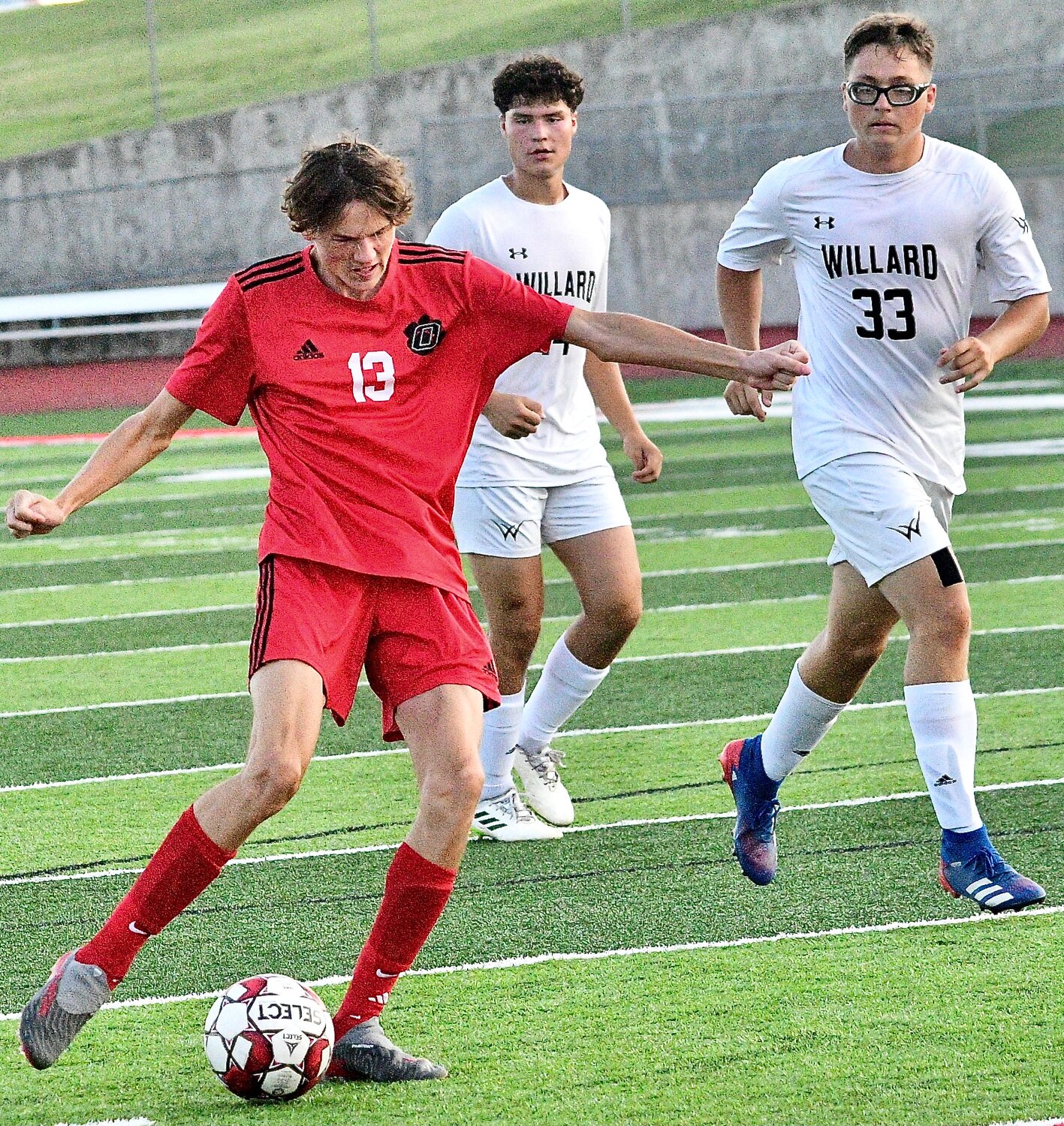 OZARK'S GRANT OGLE shoots for one of his three goals.