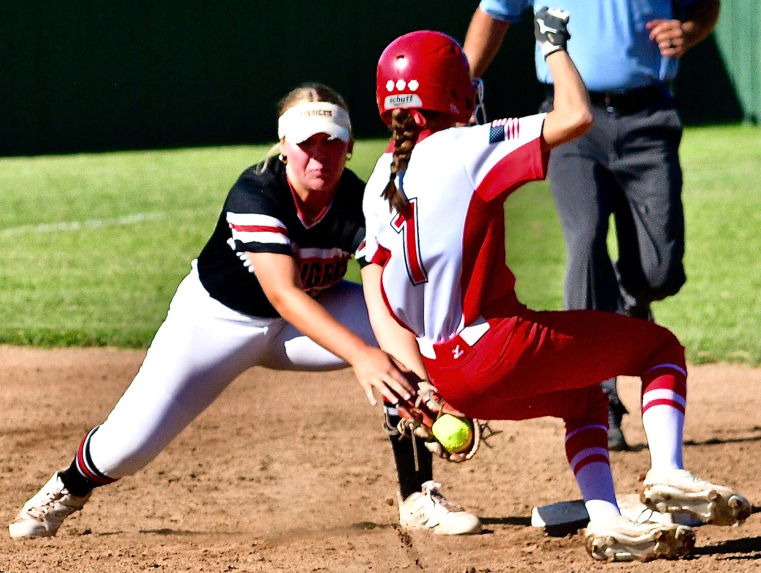 OZARK'S ADDI LEWIS is tagged out while trying to steal second base.