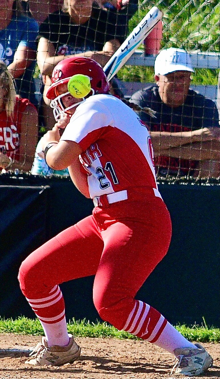 OZARK'S EMILY GRIEST avoids a high and inside pitch.
