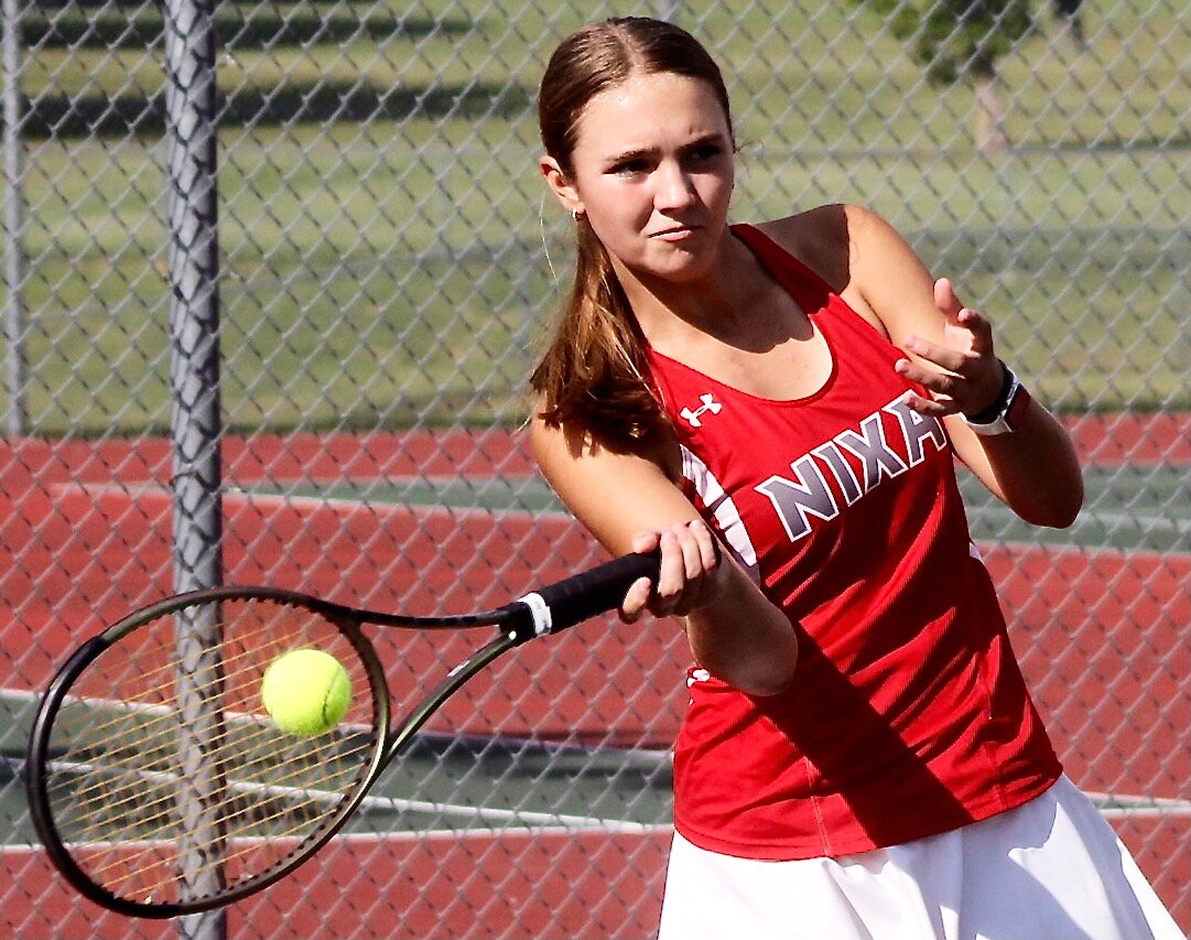 NIXA'S EMILY PETERSON connects for a forehand return.