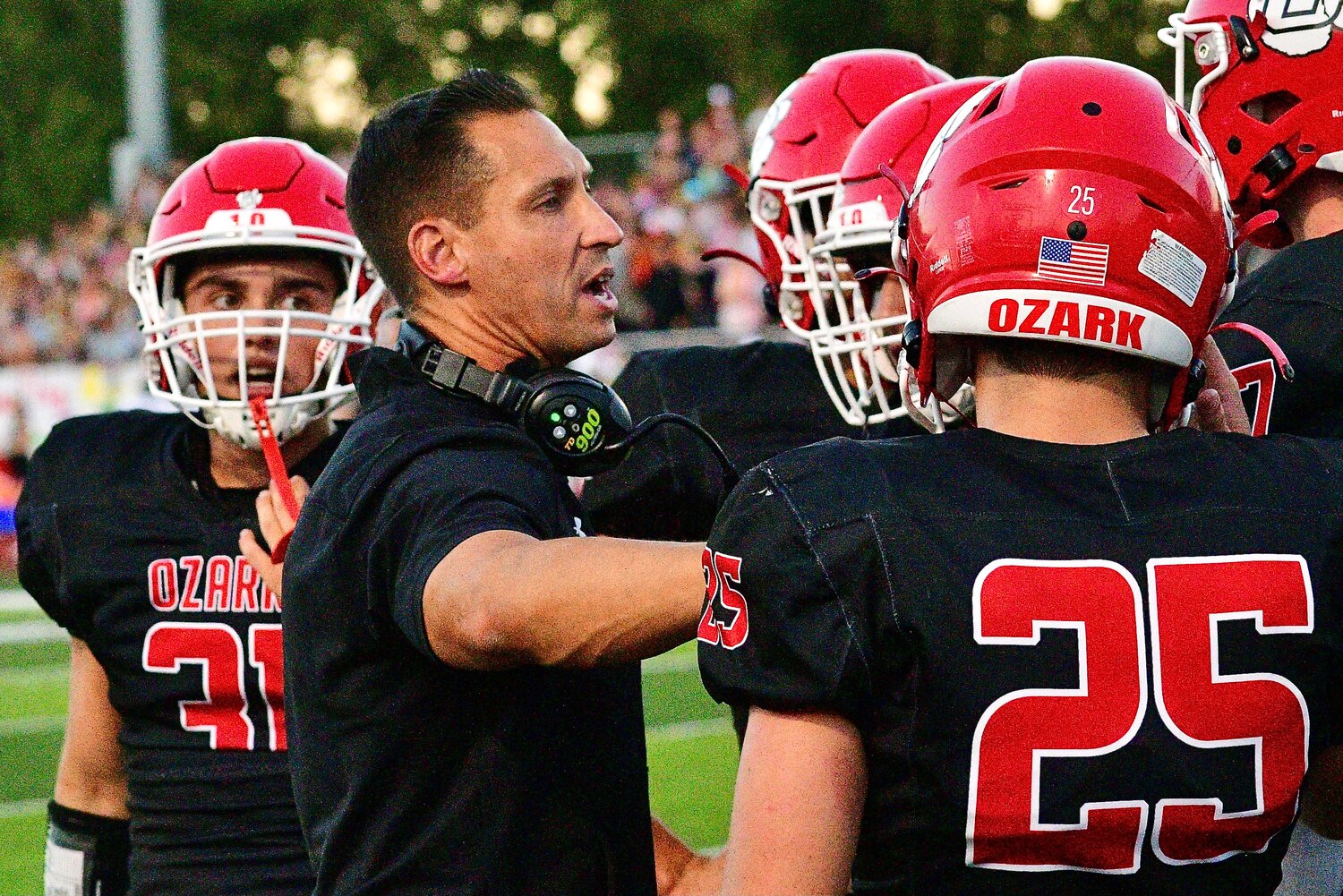 OZARK COACH JEREMY CORDELL huddles with his players.