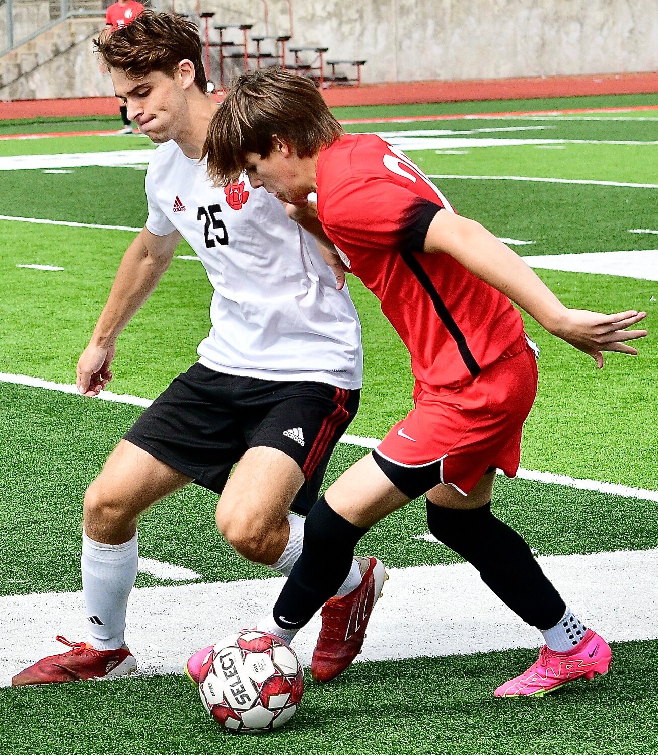 OZARK'S WYATT TROBAUGH tries to kick the ball away from a Chaminade player.