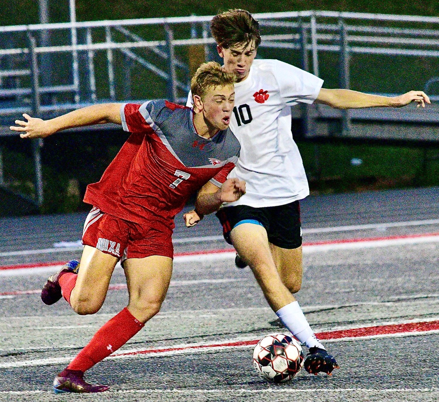 NIXA'S CAEDEN CLOUD AND OZARK'S PHIN SCOTT meet up while going after the ball.
