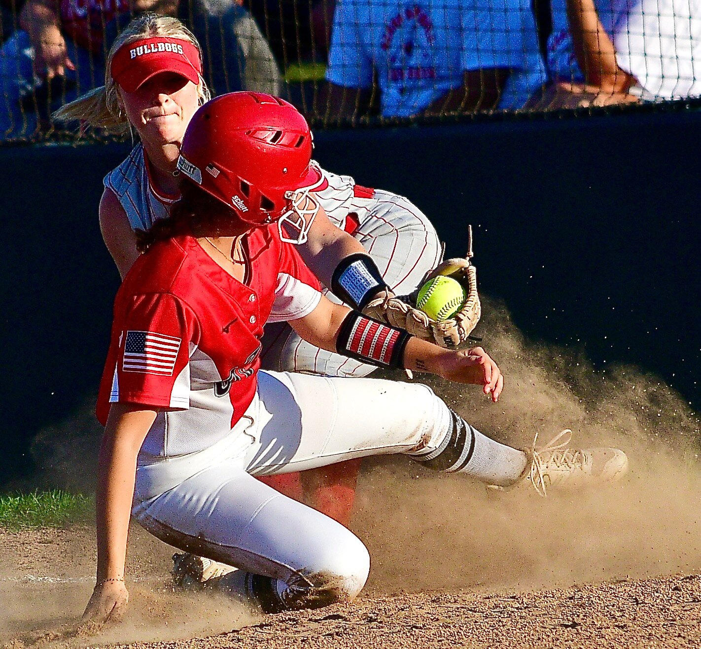 OZARK'S IZZY BRYANT is tagged as she lifts her left foot upon sliding at third base Thursday. She was called safe on the play.