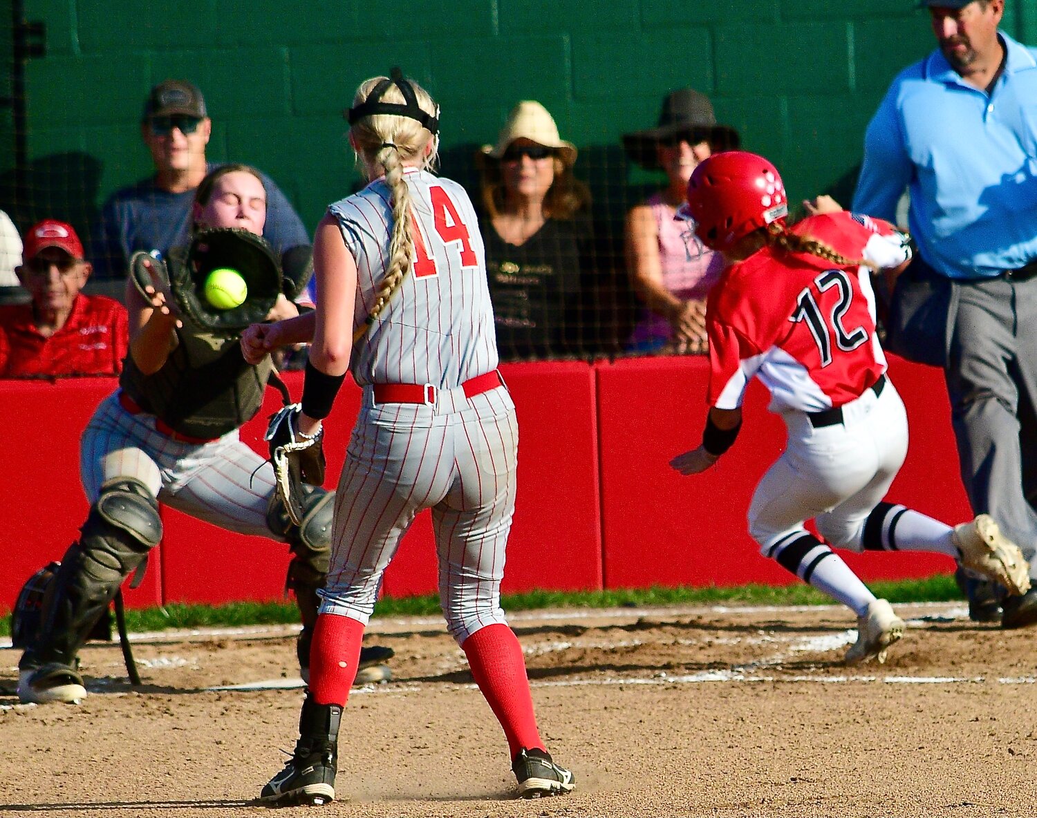 OZARK'S KENDALL MCCOY tries to beat a throw home from the Carl Junction pitcher, after a squeeze bunt. She was tagged out.