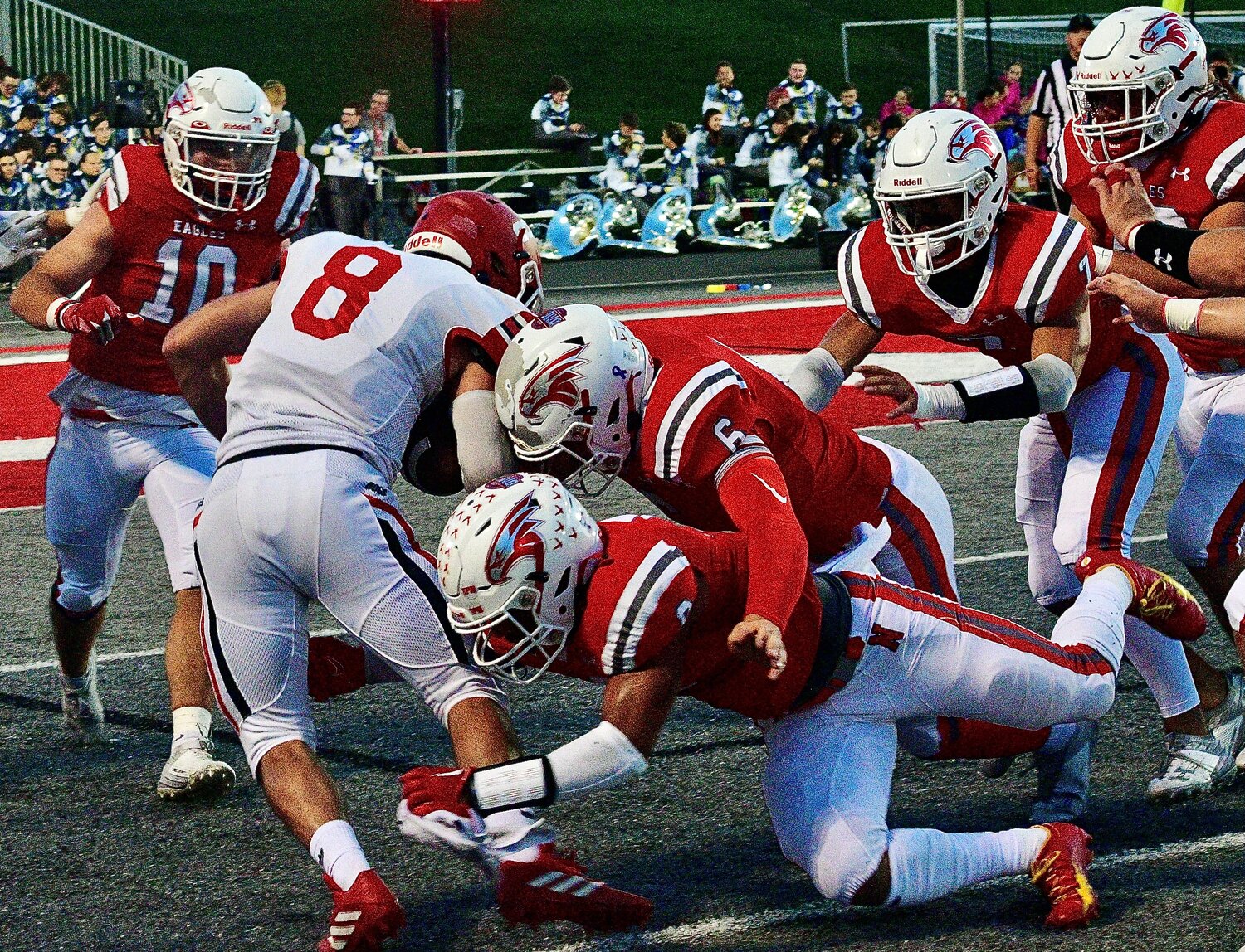 NIXA'S BRODEN MABE, JAYDEN ANTONELLI AND PARKER MANN converge on a Carl Junction ball-carrier.