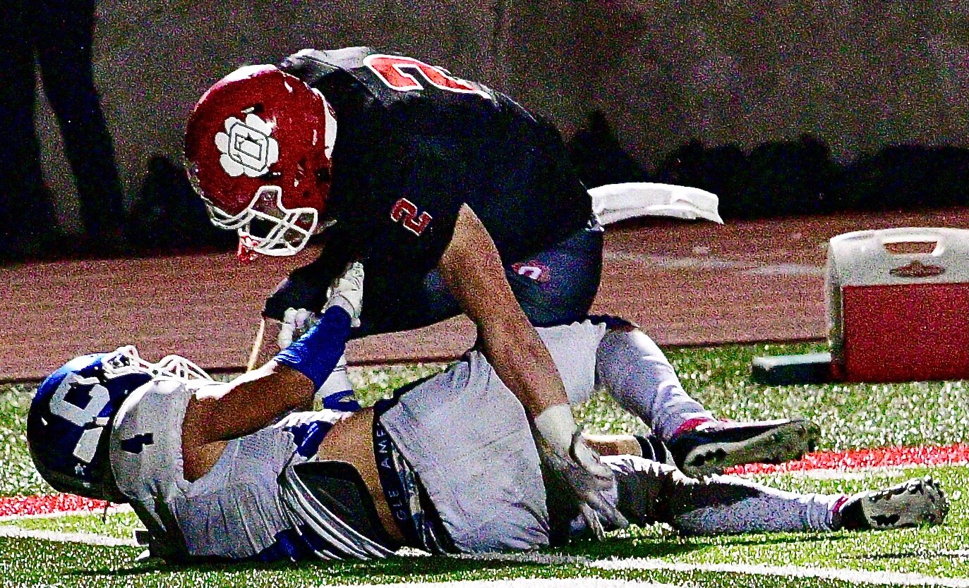OZARK'S JACK BOWERS lifts himself up off of a Carthage defender en route to a touchdown run.
