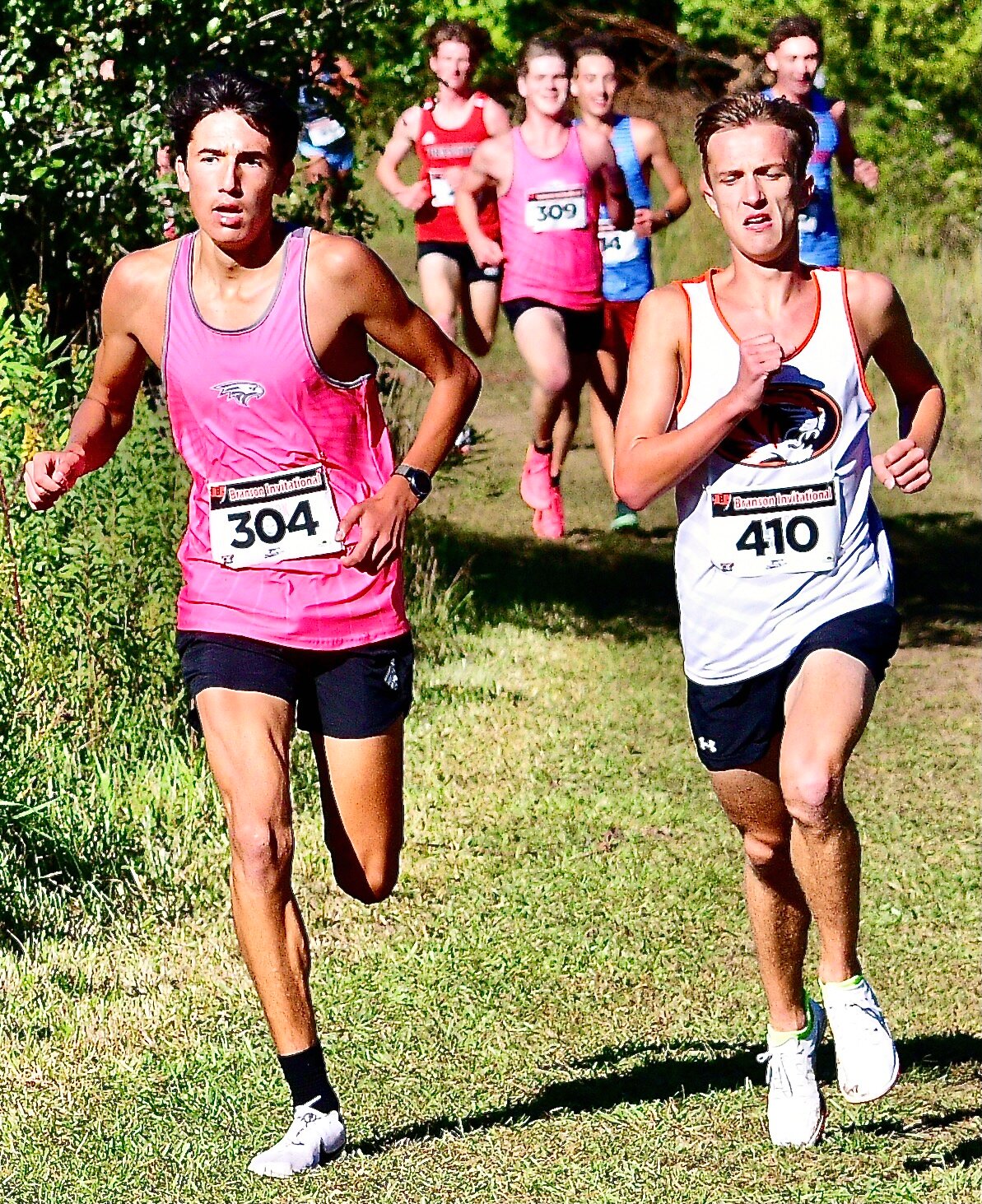 NIXA'S REYES MARTINEZ runs side-by-side with a Republic runner.