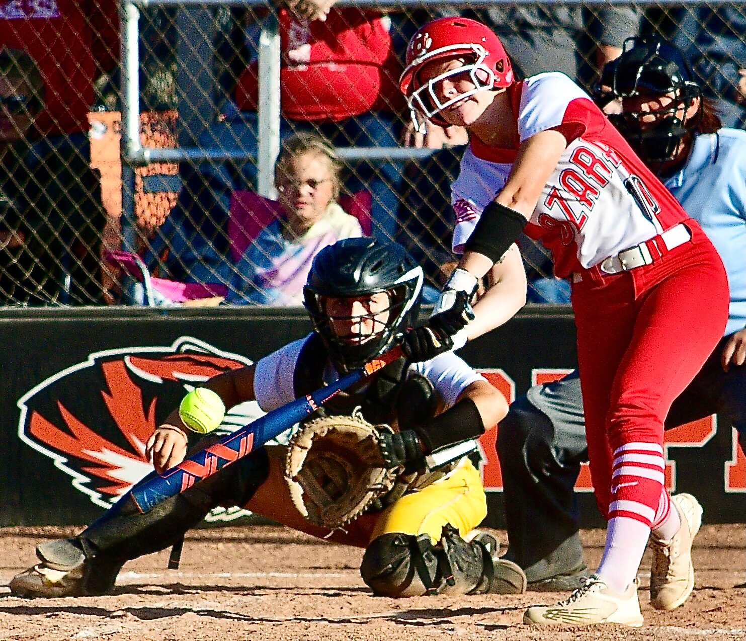 OZARK'S KAYLEE LINNEBUR reaches for a low and outside pitch and pulls it for a home run.