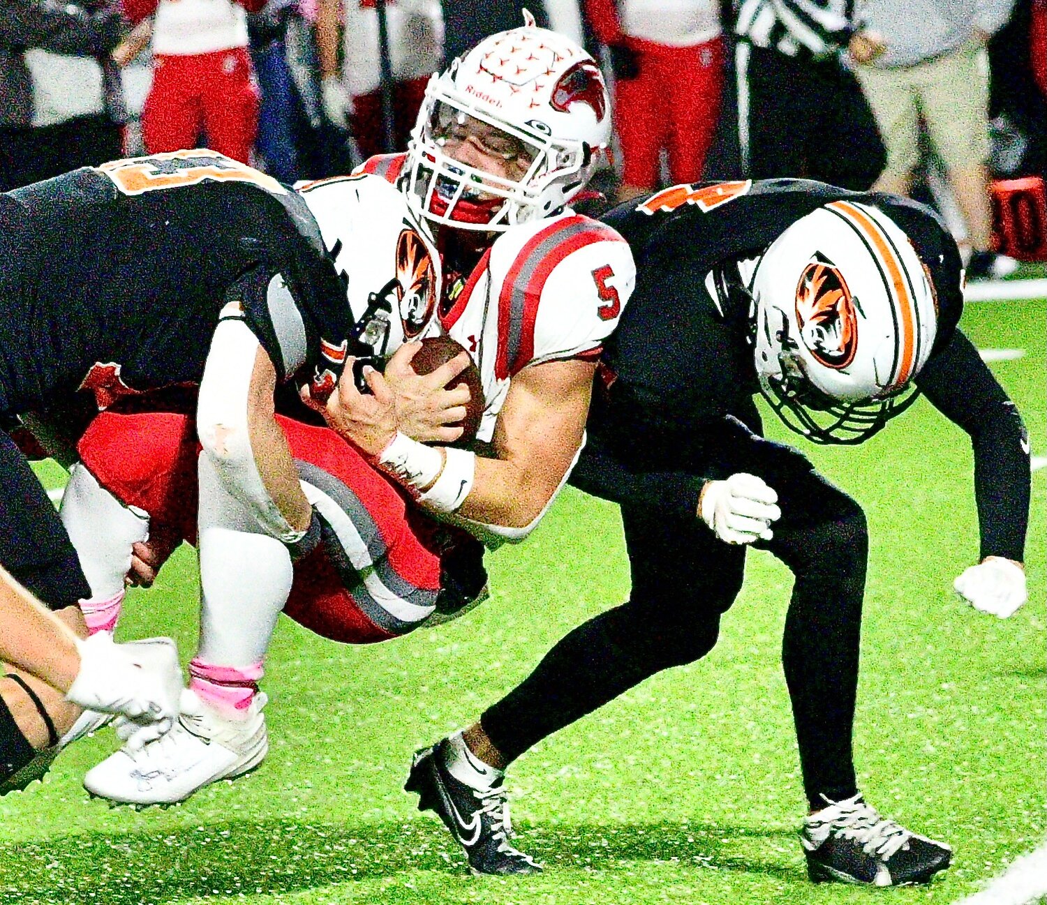 NIXA'S DYLAN REBURA is sandwiched by two Republic defenders.