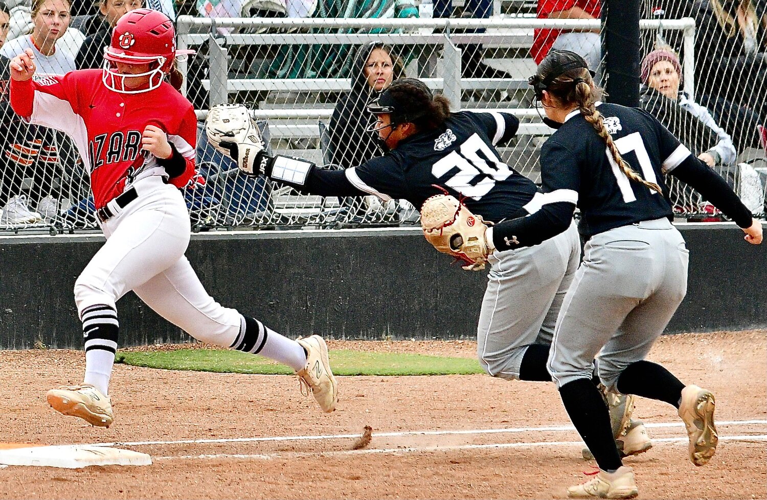 OZARK'S NATALIE MORGAN eludes a tag on her way to an infield single.