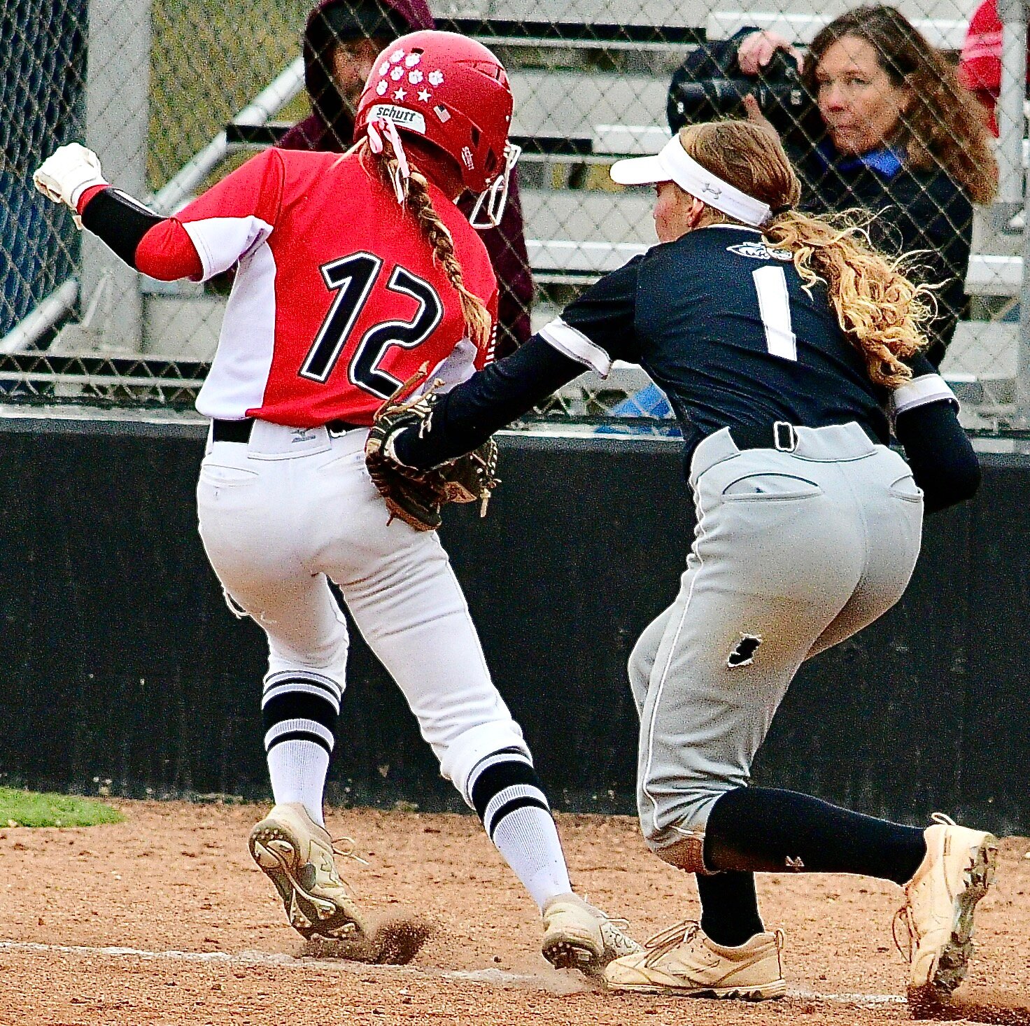OZARK'S KENDALL MCCOY is tagged out between home and third base.