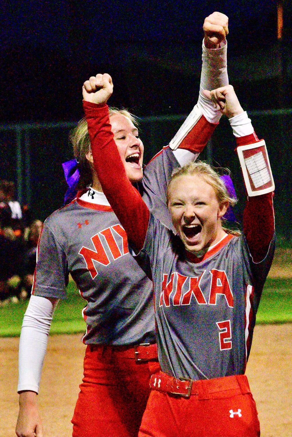 NIXA'S RYLEE HARPER AND GRACE WEST lead the Lady Eagles' cheers.