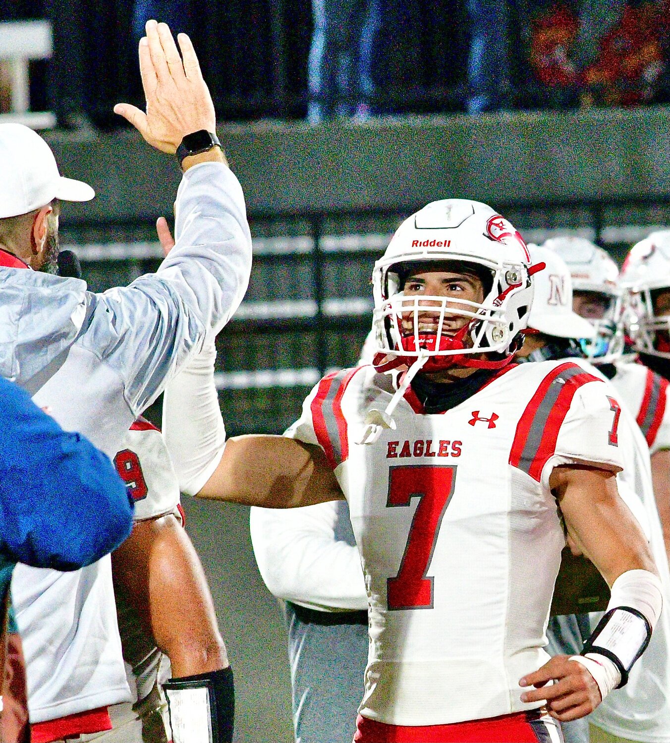 NIXA'S PARKER MANN gets set to exchange a high-five with an assistant coach.