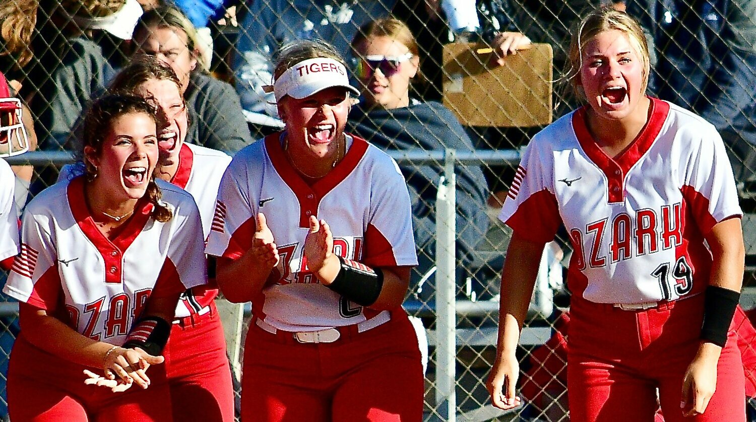 OZARK'S AUDREY CARLTON, right, leads the Lady Tigers' cheers during a home run celebration.