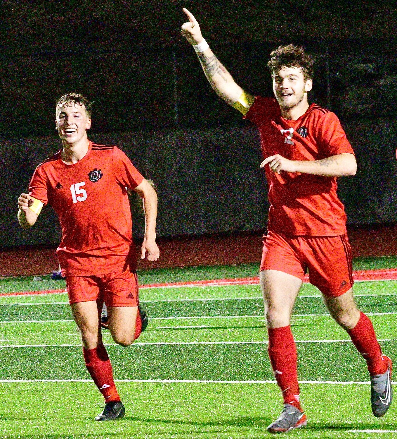 OZARK'S AUGUST MCCOMAS AND CONNOR CUMMINGS begin the Tigers' celebration.