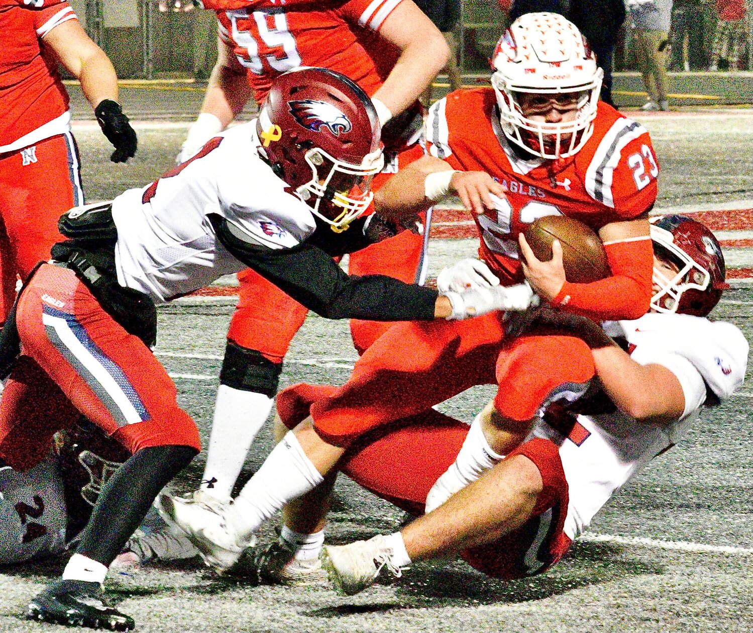 NIXA'S MALACHI RIDER secures the pigskin while being tackled.