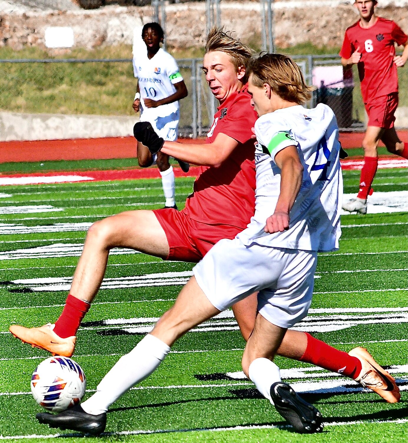 OZARK'S ZACH ULRICH and a Rockhurst player converge on the ball.