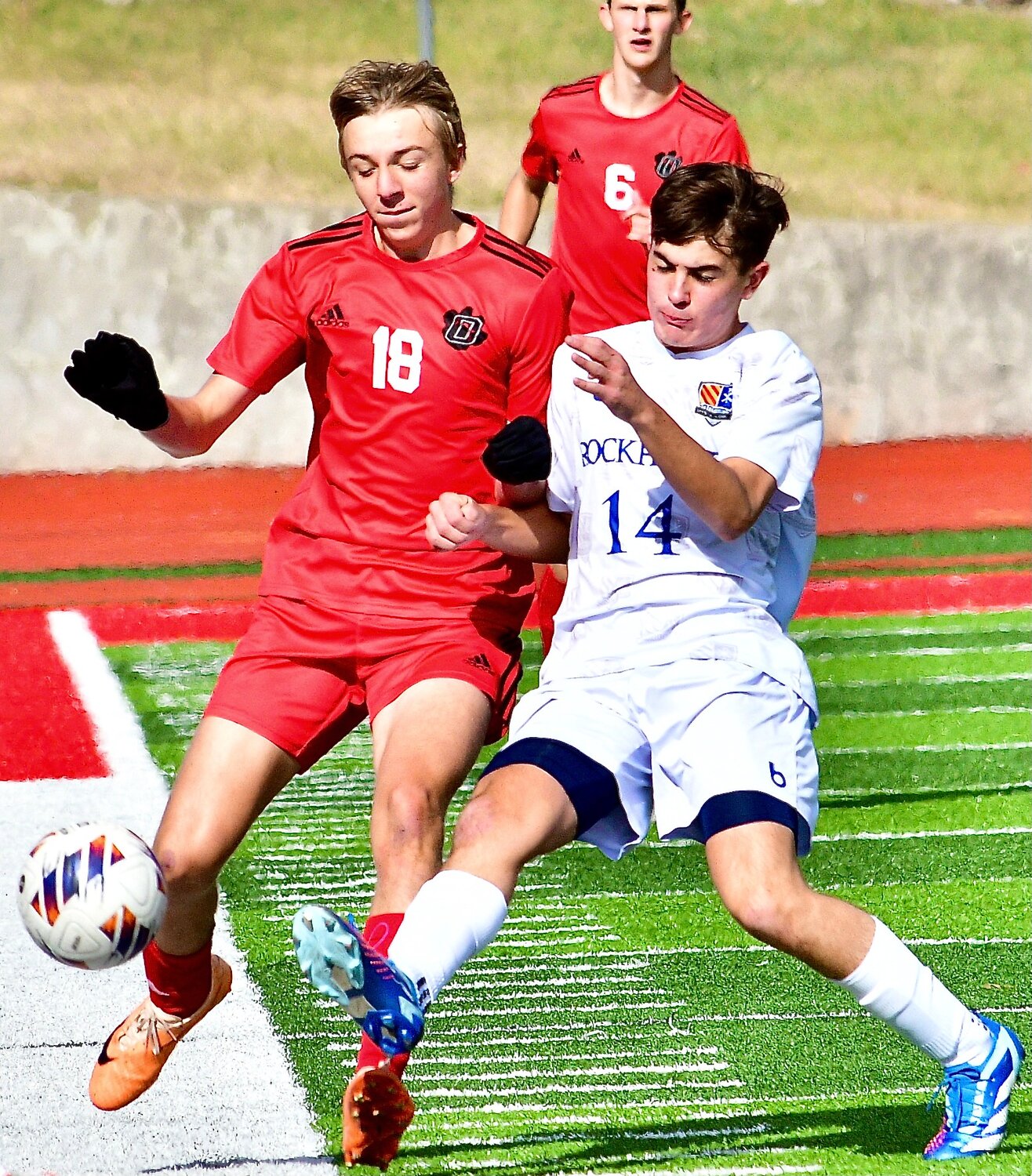 OZARK'S ZACH ULRICH and a Rockhurst player battle for control of the ball.