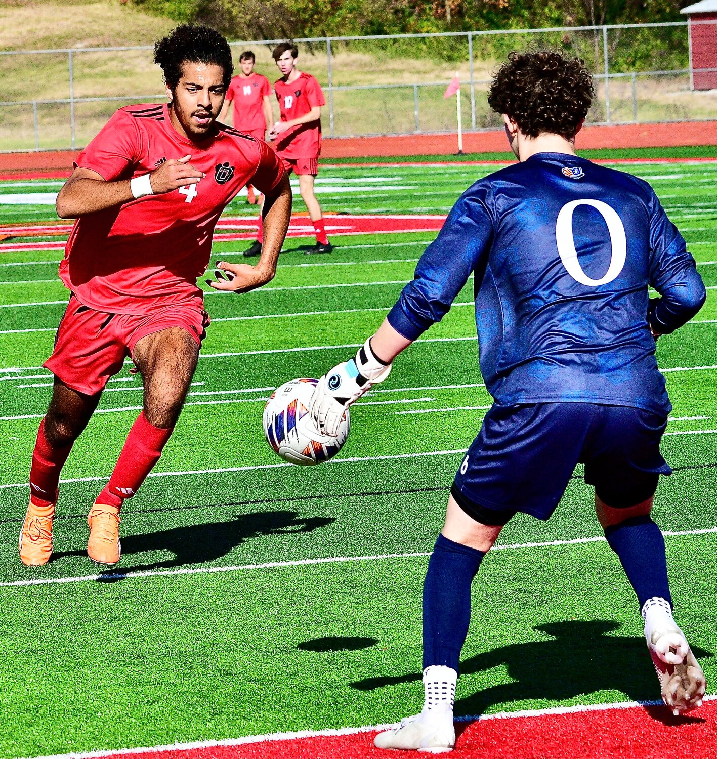 OZARK'S ALEX WILLIAMS tries to get to the ball before it rolls to the Rockhurst 'keeper.