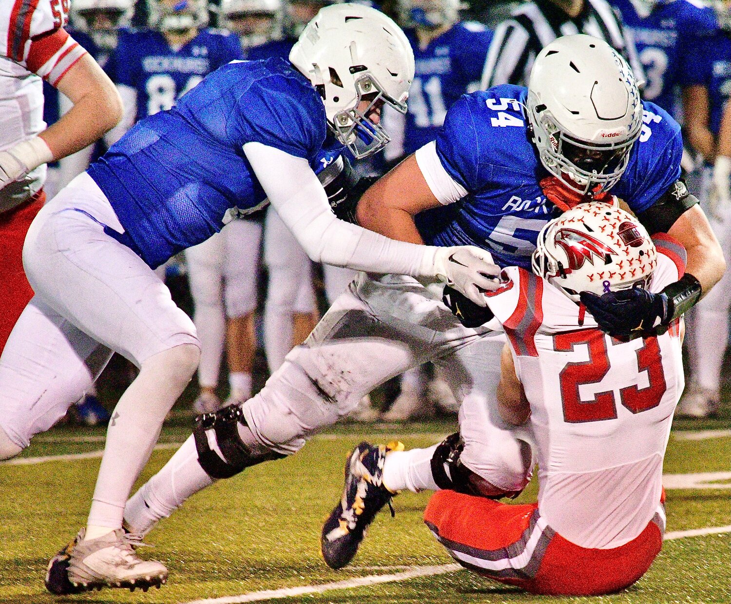 NIXA'S MALACHI RIDER is brought to the turf by Rockhurst defensive lineman Andrew Sprague on Friday.