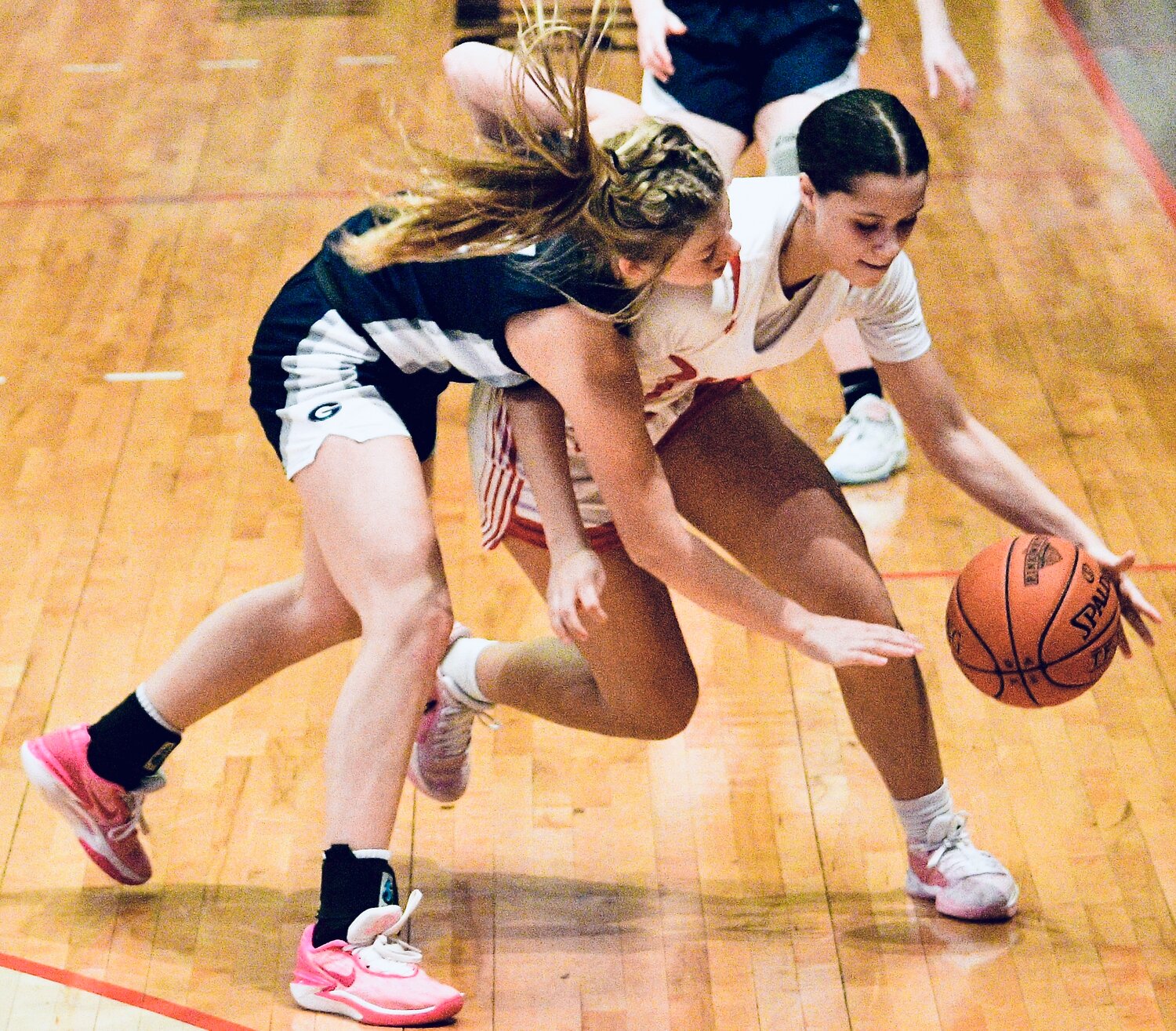 NIXA'S ADDY RUFFIN maintains control of the ball as a Greenwood player reaches across her.