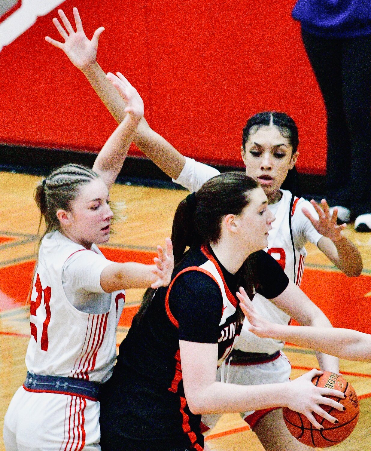 NIXA'S TAYLOR WOOD AND LAILA GRANT surround a Carl Junction player.
