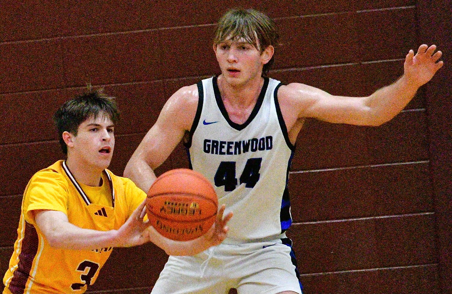 SPOKANE'S DAVID BLAKE makes a pass in front of a Greenwood defender.