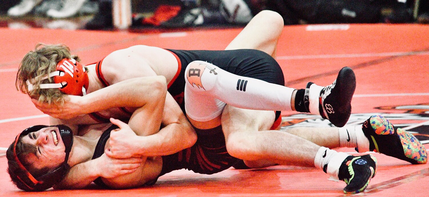 OZARK'S KEATON HURST sets himself up for a pin during the Tigers' home dual with Branson on Tuesday.