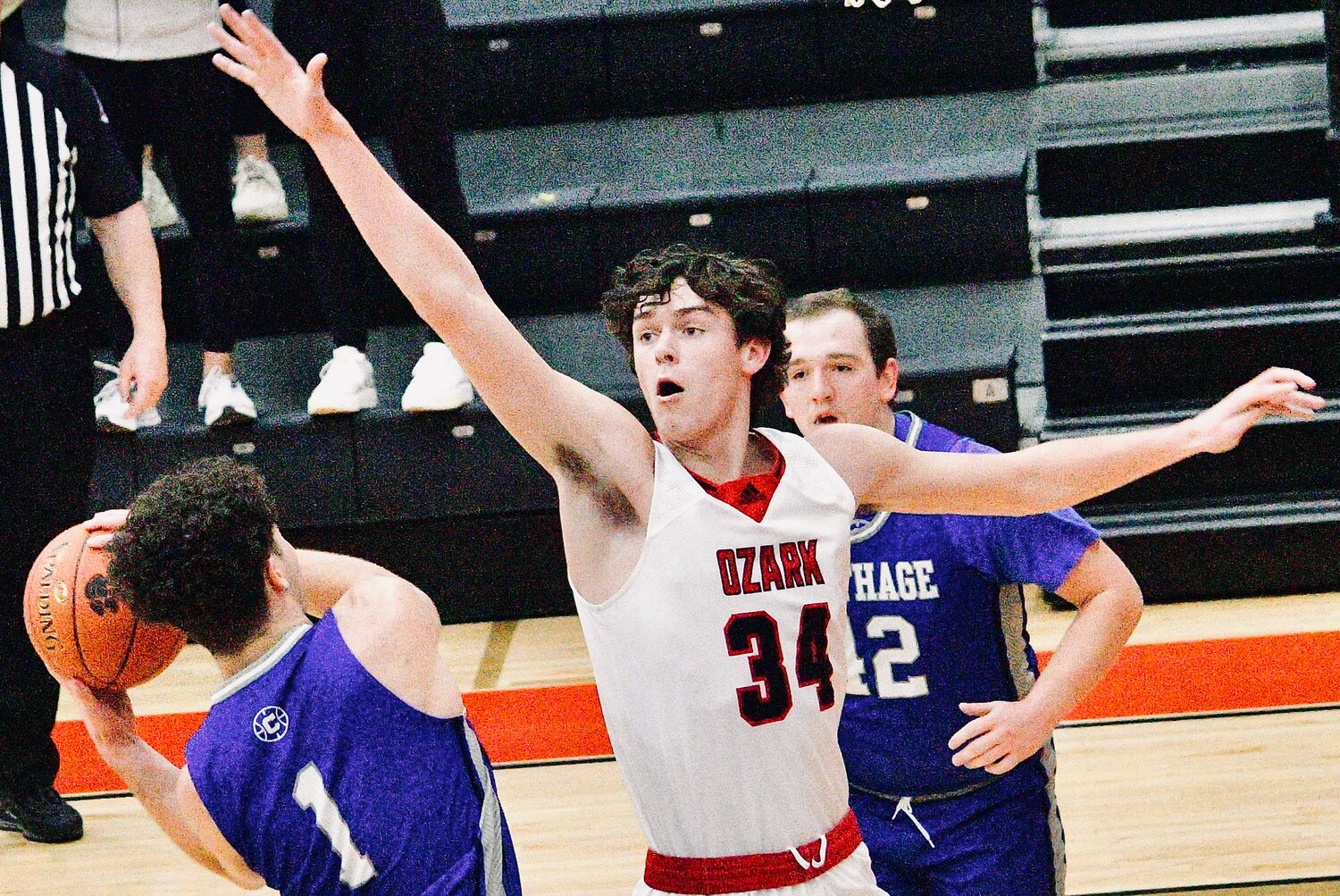 OZARK'S COHEN GEORGE stands between a Carthage player and the basket Wednesday.