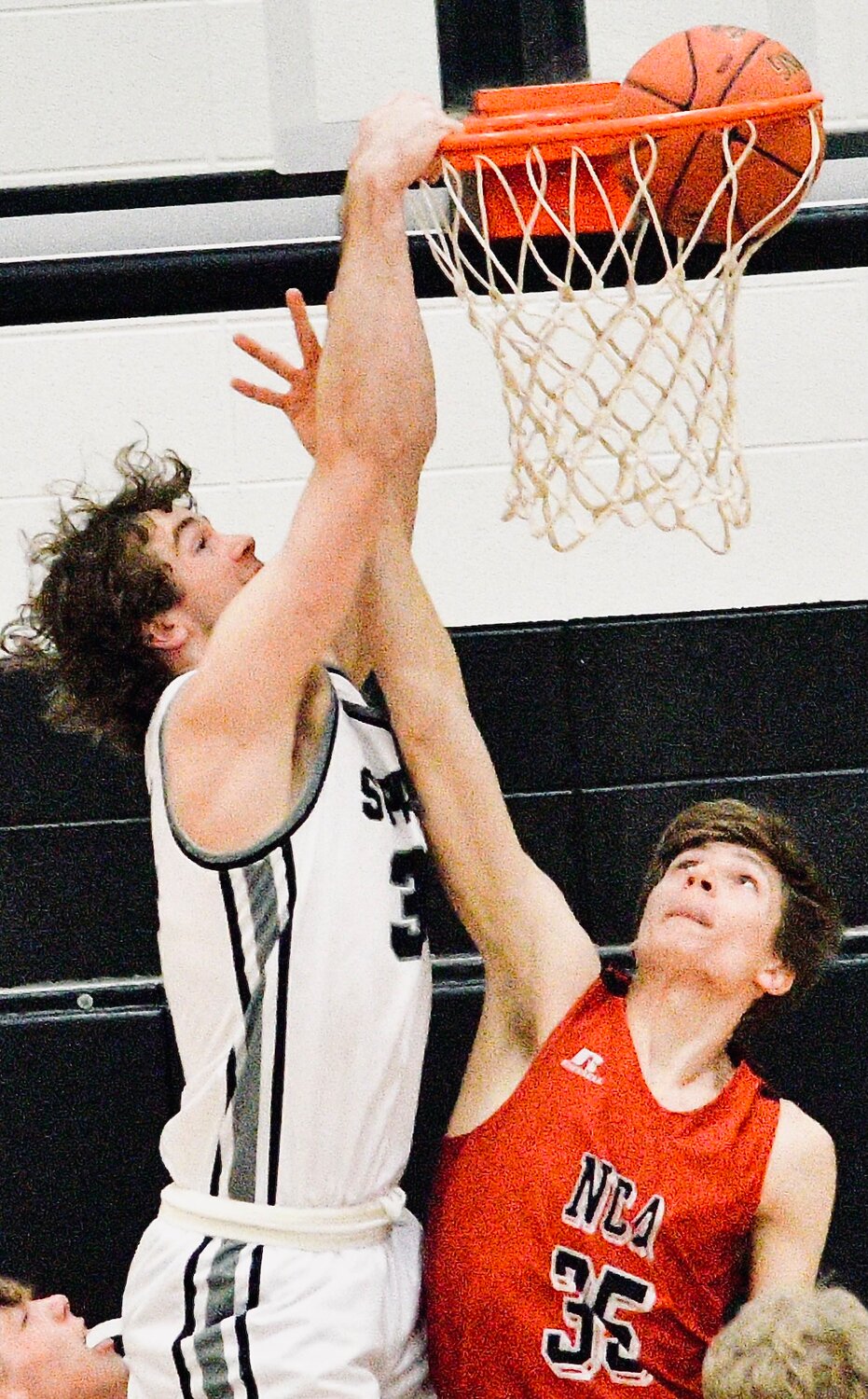 SPARTA'S JAKE LAFFERTY dunks on a New Covenant player.