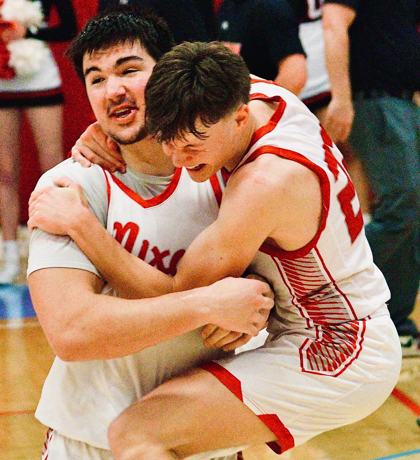 NIXA'S GARRETT HINES jumps into the arms of teammate Jackson Cantwell.