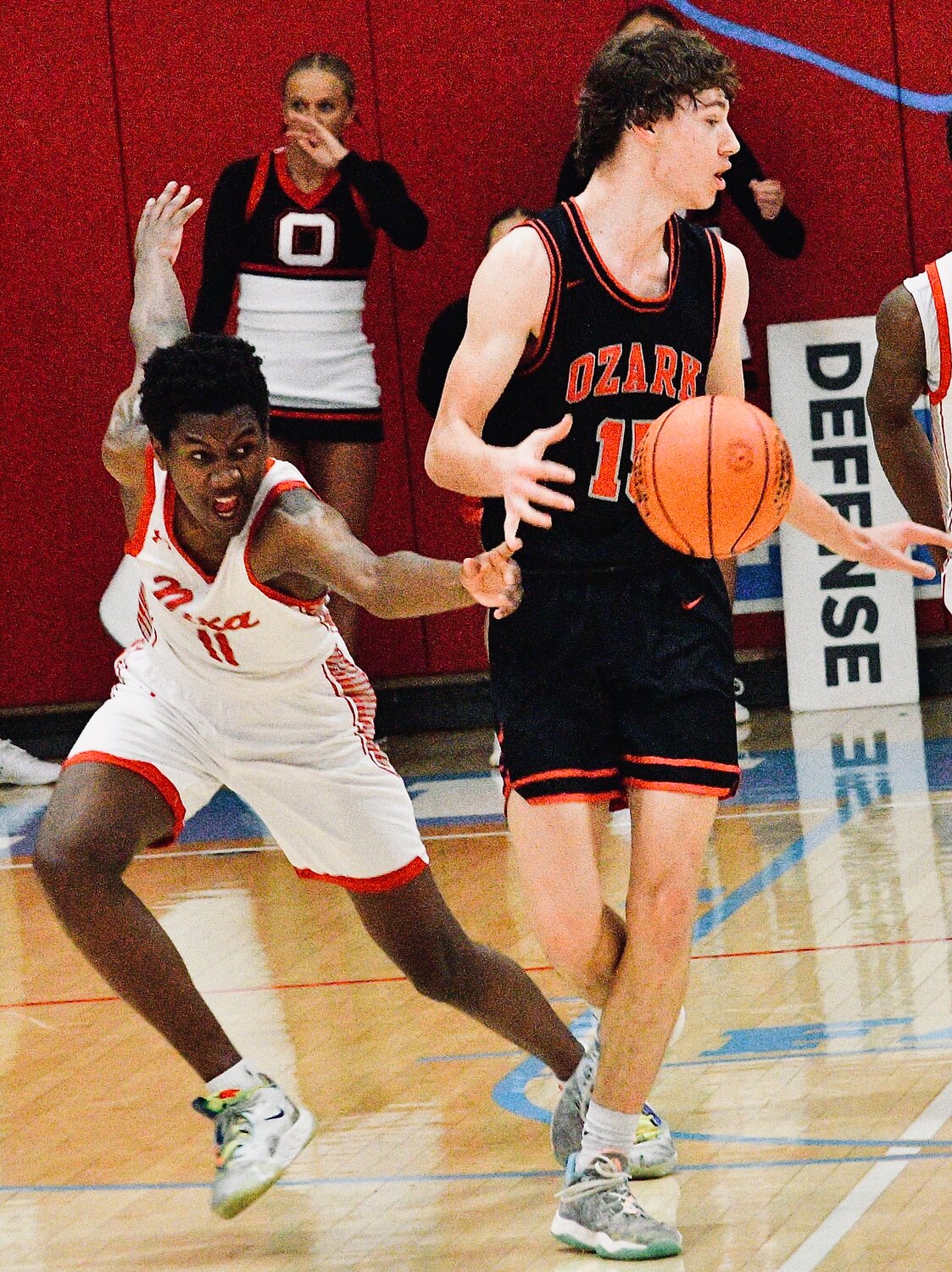 NIXA'S JAISE COMBS goes for a steal against Ozark's Hudson Roberts.