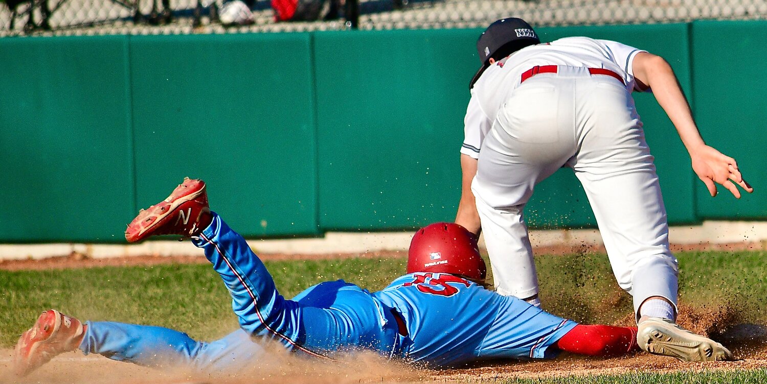 NIXA'S NATE UBER goes to his left for a tag as a Glendale baserunner sneaks his hand onto first base.