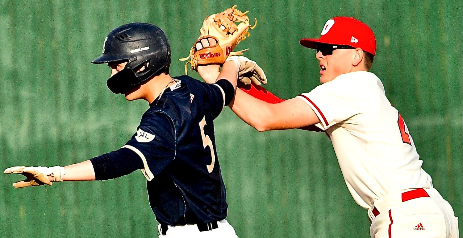 OZARK'S TRUMAN GRIESSEL and a Helias player get tangled up at second base.