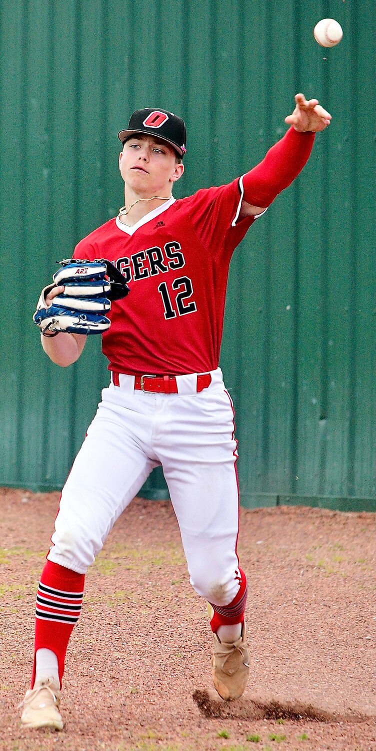 OZARK'S RYLAN SUTTON makes a throw from right field.