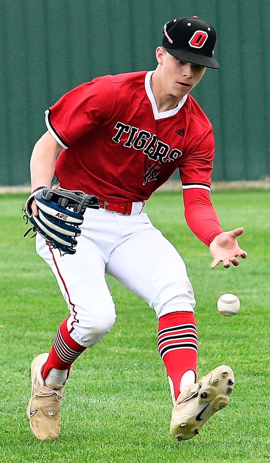 OZARK'S RYLAN SUTTON tracks down the ball in right field.