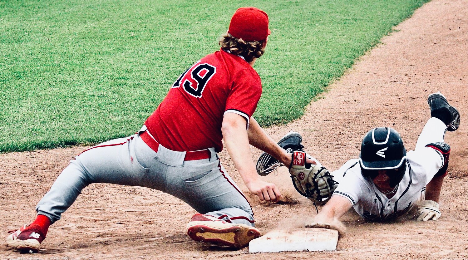 OZARK'S GEORGE REYNOLDS applies a tag during a pickoff attempt.