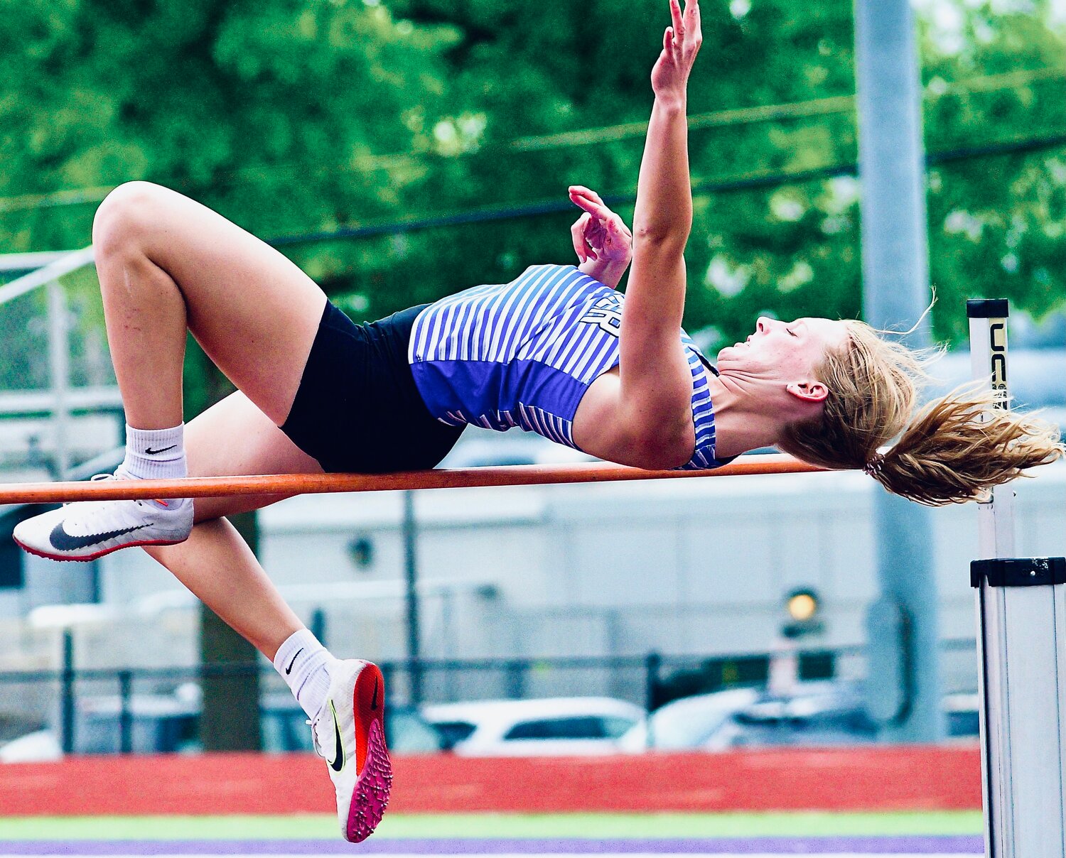 CLEVER'S VALERIE COWLES works her way over the bar in the high jump.