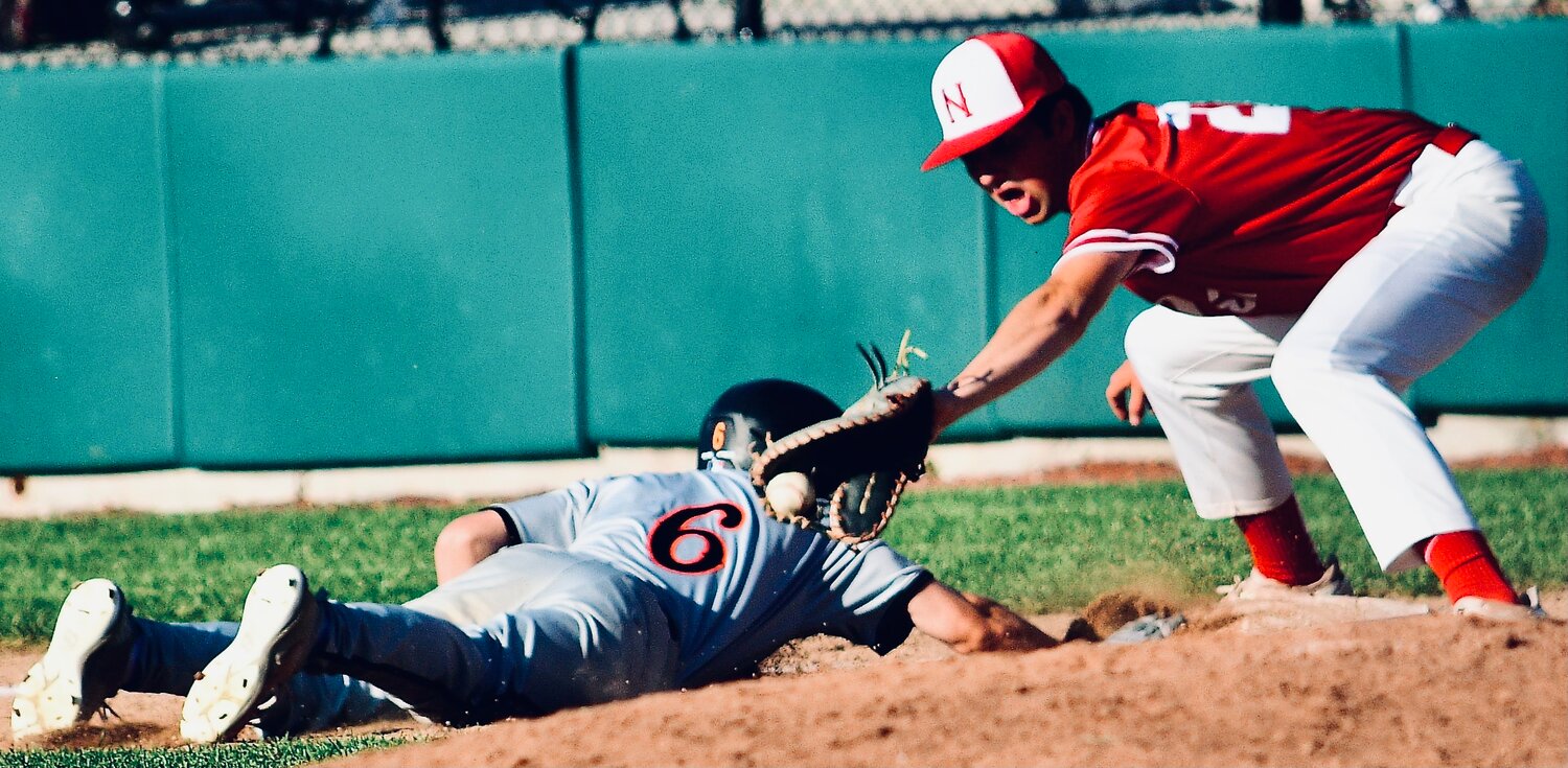 NIXA'S NATE UBER prepares to apply a tag on a pick-off attempt.
