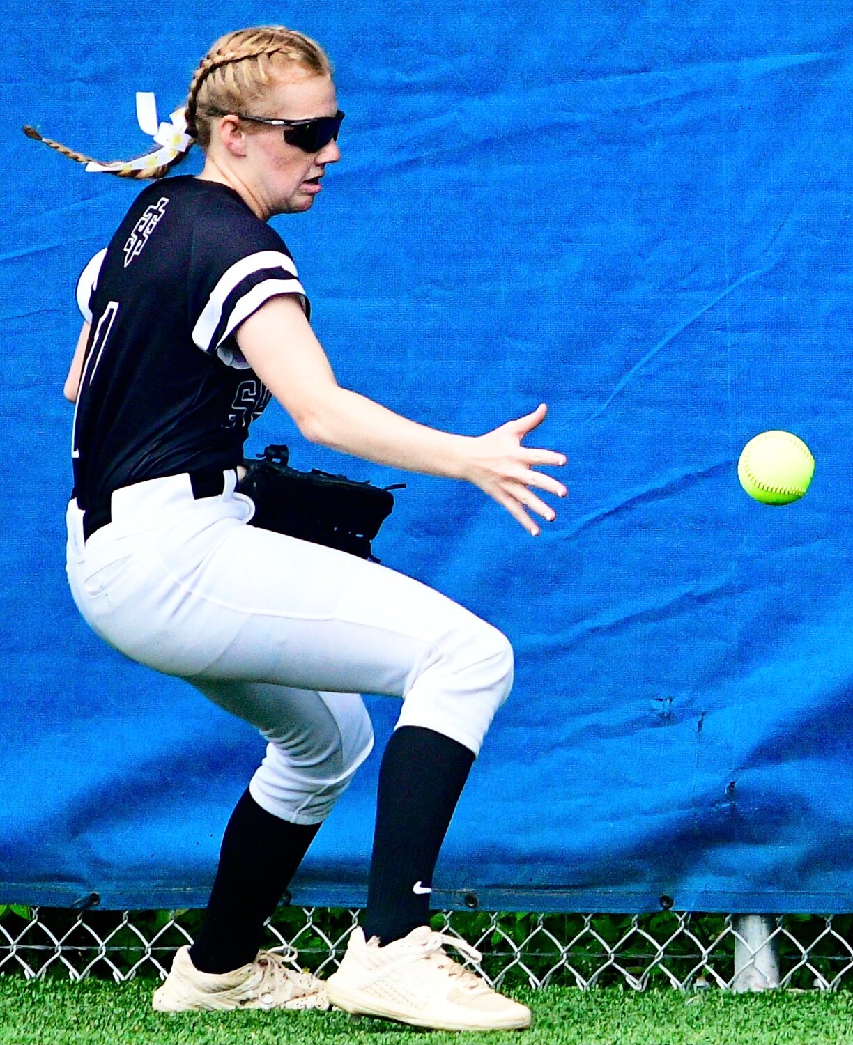 SPARTA'S MYA FULTON fields the ball off the center field fence.